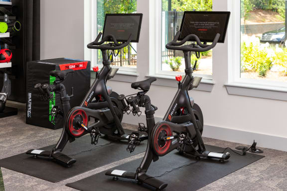 a group of exercise bikes in a gym