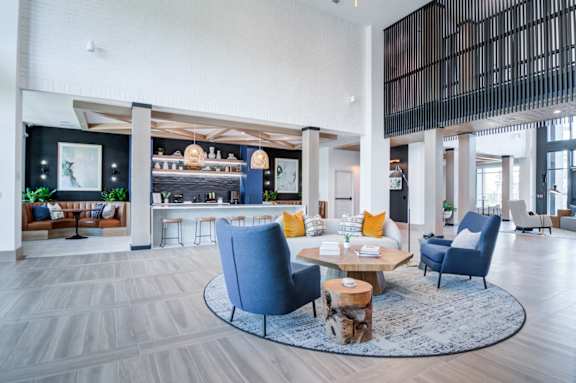 A modern living room with a blue chair and a coffee table.