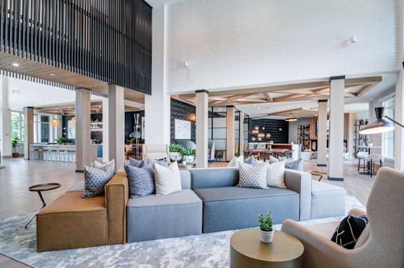 A modern living room with a grey sofa and a wooden coffee table.