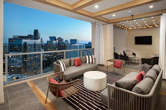 A living room with a city view through the window.