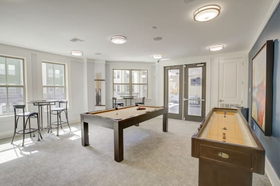 a games room with two pool tables and a foosball table  at The Ivy Residences at Health Village, Orlando, FL, 32804