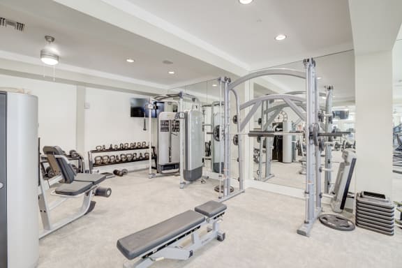 a fully equipped fitness room with free weights and cardio equipment  at The Ivy Residences at Health Village, Orlando, FL