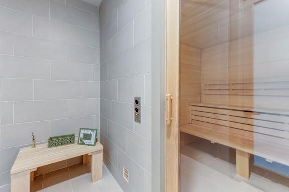 A sauna room with a bench and a table.