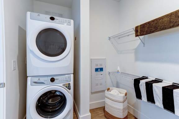 A white washing machine and dryer in a small laundry room.