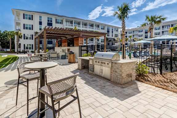 A patio area with a table and chairs in front of a building.