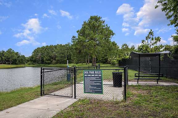 A sign at the entrance of a dog park lists the rules.
