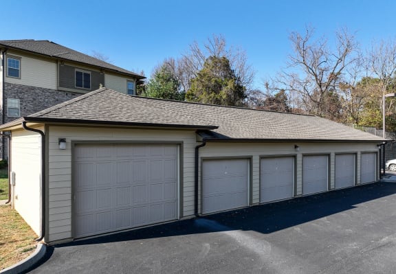 a 3 car garage with a house behind it