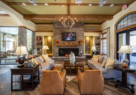 a living room with couches and chairs and a fireplace