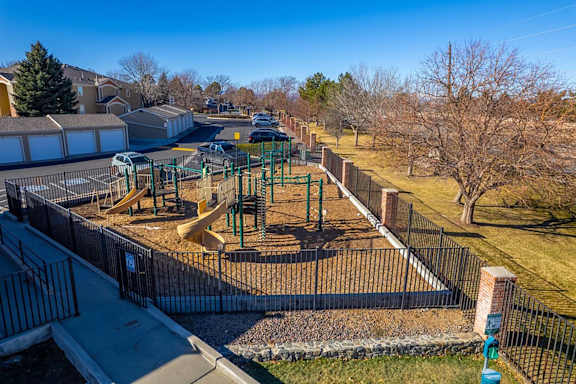 A playground with a slide and a swing set.