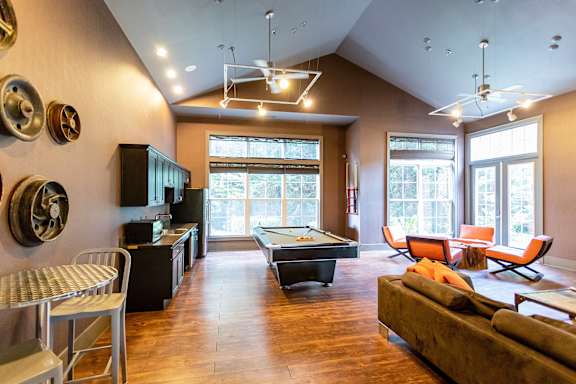 A room with a pool table and a couch.