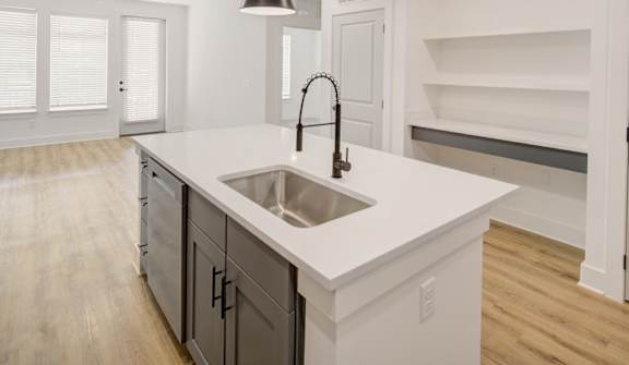 A kitchen with a sink and a countertop.