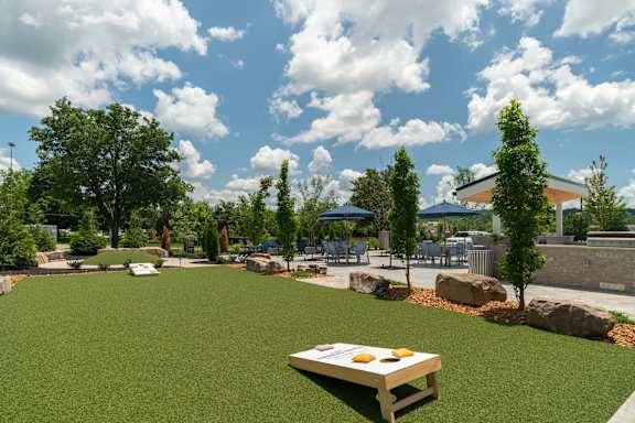 A picnic table is in the middle of a grassy area.