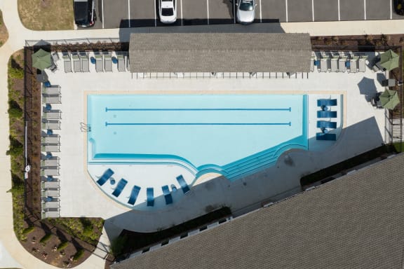 an overhead view of a swimming pool in a parking lot