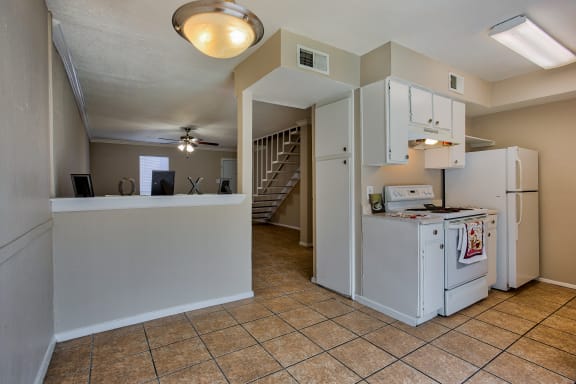 the kitchen is open to the living room and dining room