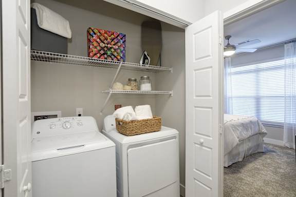 A small laundry room with a washer and dryer.