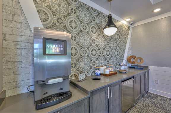 A modern kitchen with a stainless steel coffee machine and a digital display on the counter.