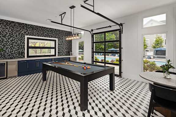 A black and white checkered floor in a room with a pool table.