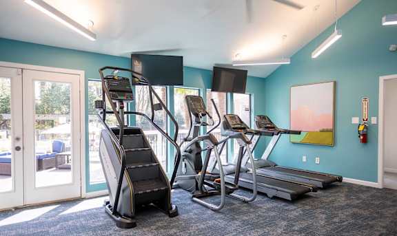 A gym with treadmills, elliptical machines, and a stair climber.