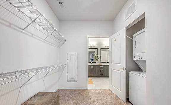 A white kitchen with a white fridge and a white oven.