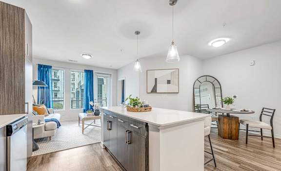 A modern kitchen with a dining table and chairs.
