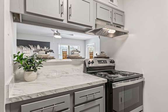A kitchen with a stove top oven and a counter top.