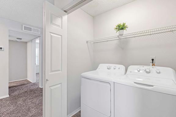 A small laundry room with a washer and dryer.