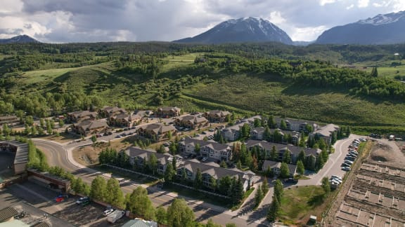a aerial view of a neighborhood with a mountain in the background