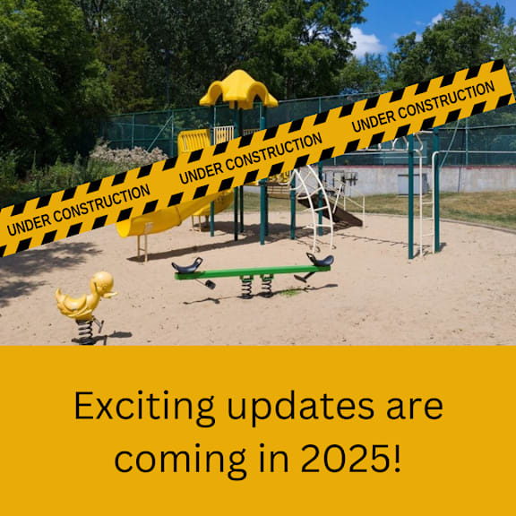 A playground with a yellow rubber duck and a caution tape that reads "UNDER CONSTRUCTION".