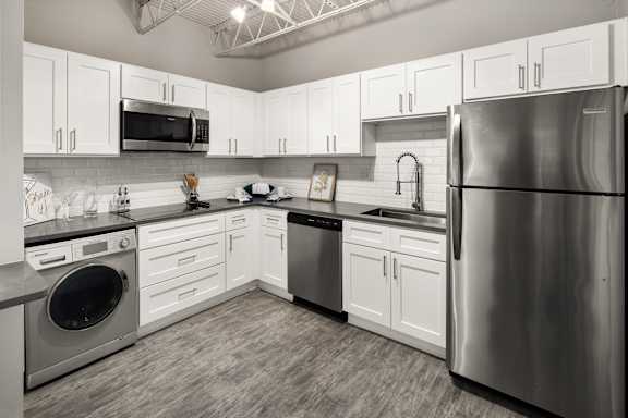 a kitchen with white cabinets and stainless steel appliances at Elevate 758, Mobile, AL
