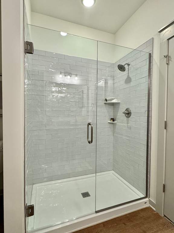A glass shower stall with a white door and a white tiled wall at Allier Foley, Alabama 36535