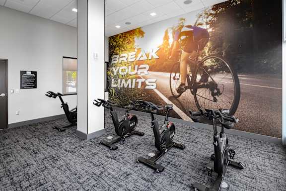 a wall mural in an office gym with a cyclist on a bike at Tower on Tenth Apartments, Birmingham