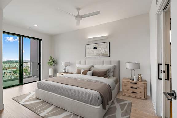B3 - large bedroom with ceiling fan and balcony access