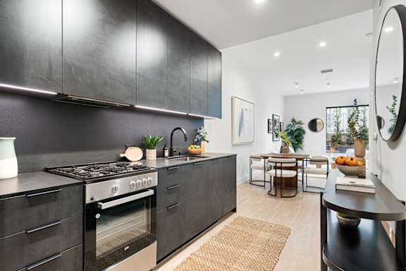 B5 - kitchen with dark finishes and stainless steel appliances