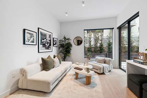 B5 - living room with large windows and open balcony