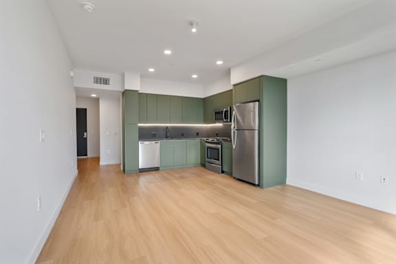 A kitchen with wooden floors and stainless steel appliances.
