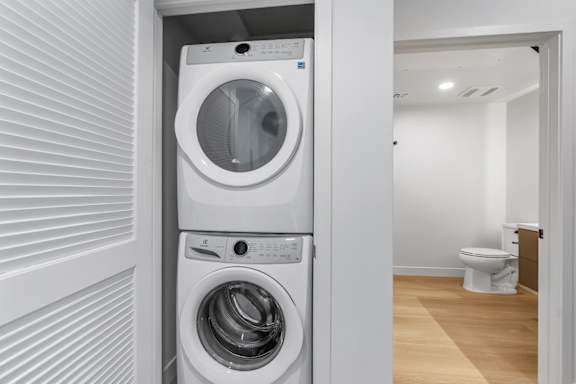 A white washing machine and dryer in a small laundry room.