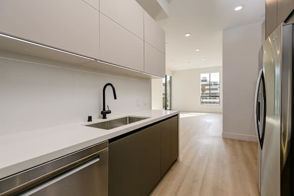 Galley style kitchen with quartz counters