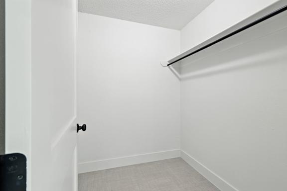 A white door with a black handle is in a room with white walls.
