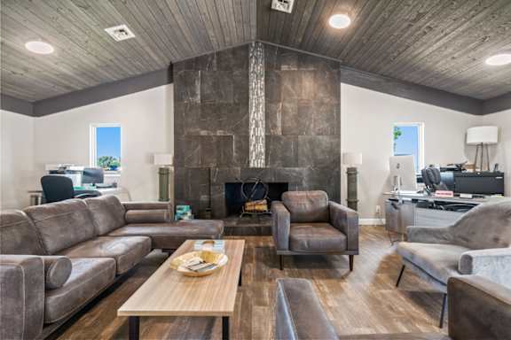 a living room with couches and chairs and a fireplace