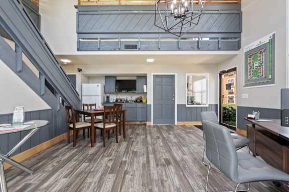 a living room and kitchen with a table and chairs