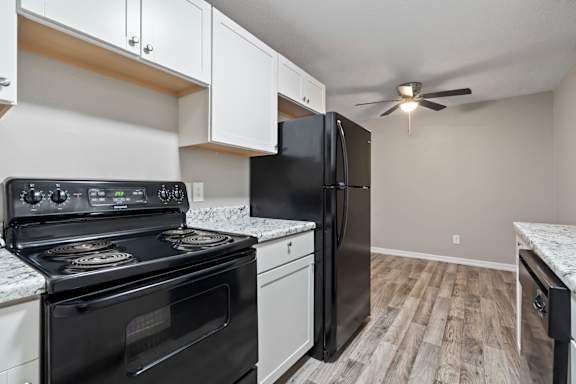 a kitchen with black appliances and a black refrigerator