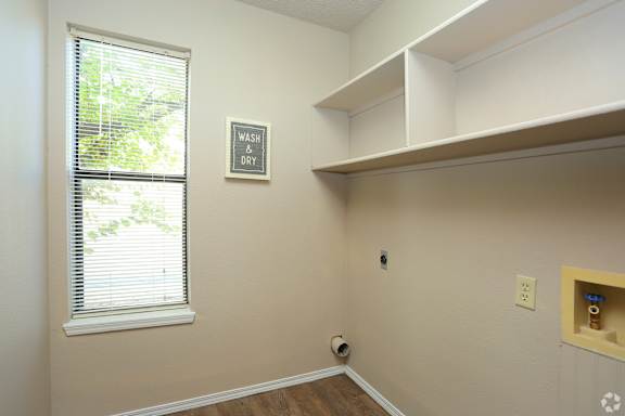 A laundry room with a sign that says