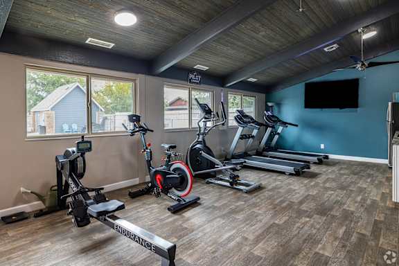 A spacious home gym with a variety of exercise equipment.