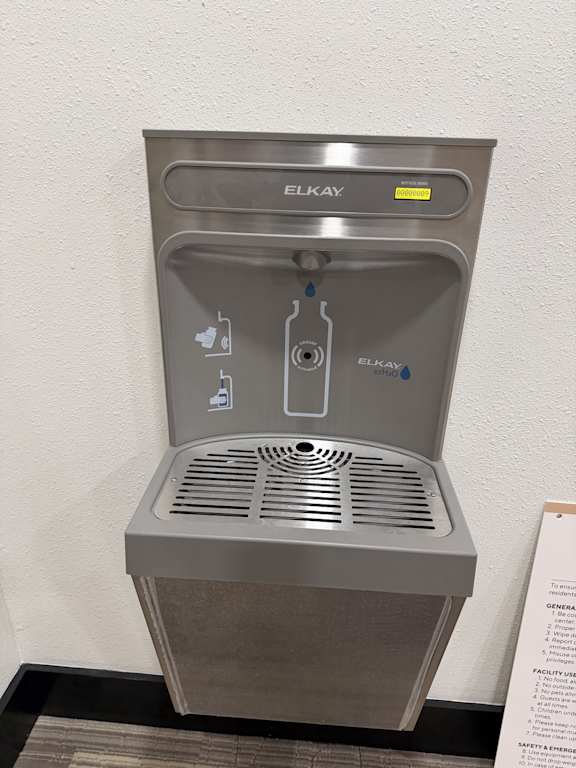 A gray water fountain with the word "ELKAY" on the top.