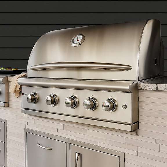 A stainless steel oven with a clock on the front and four burners below it.