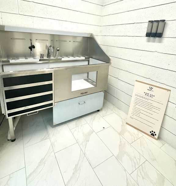 A white sink with a sign on the right.