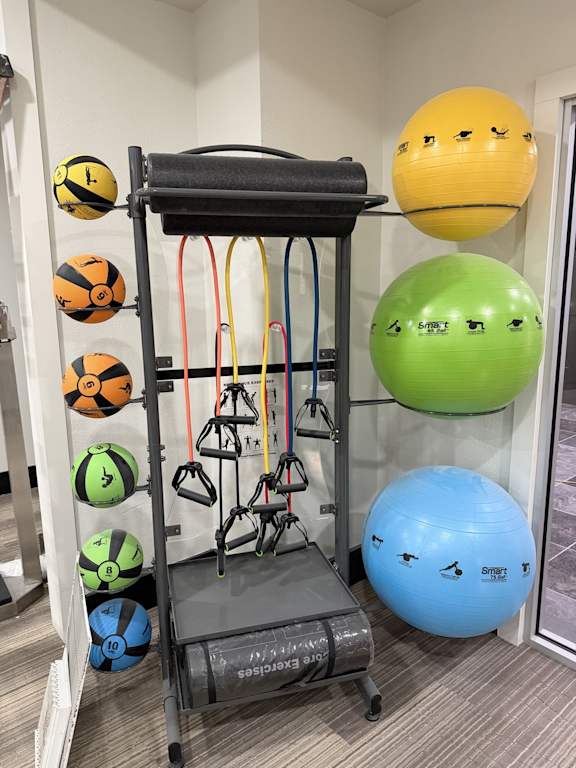 A set of exercise equipment with balls of different colors and sizes.