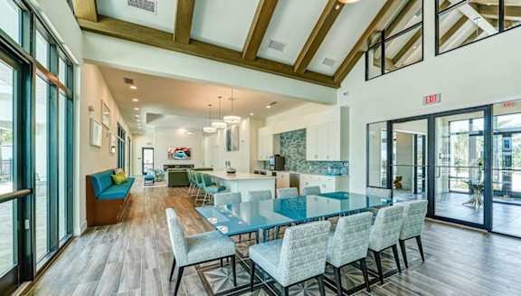 A modern dining room with a glass table and chairs.