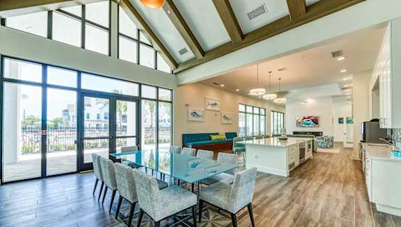 A modern kitchen with a dining table and chairs.