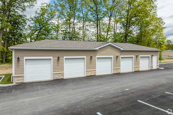 A two-car garage with a brick exterior and white doors.